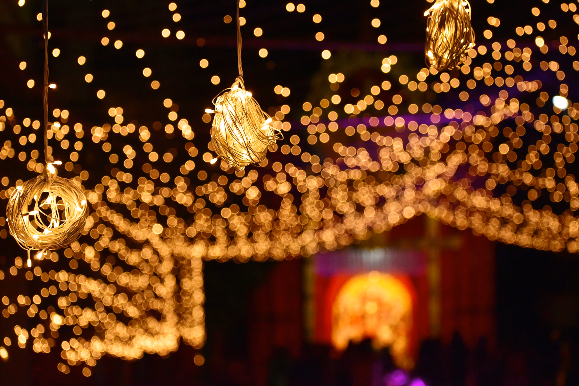 The reception's string-light canopy, the stage glowing behind.